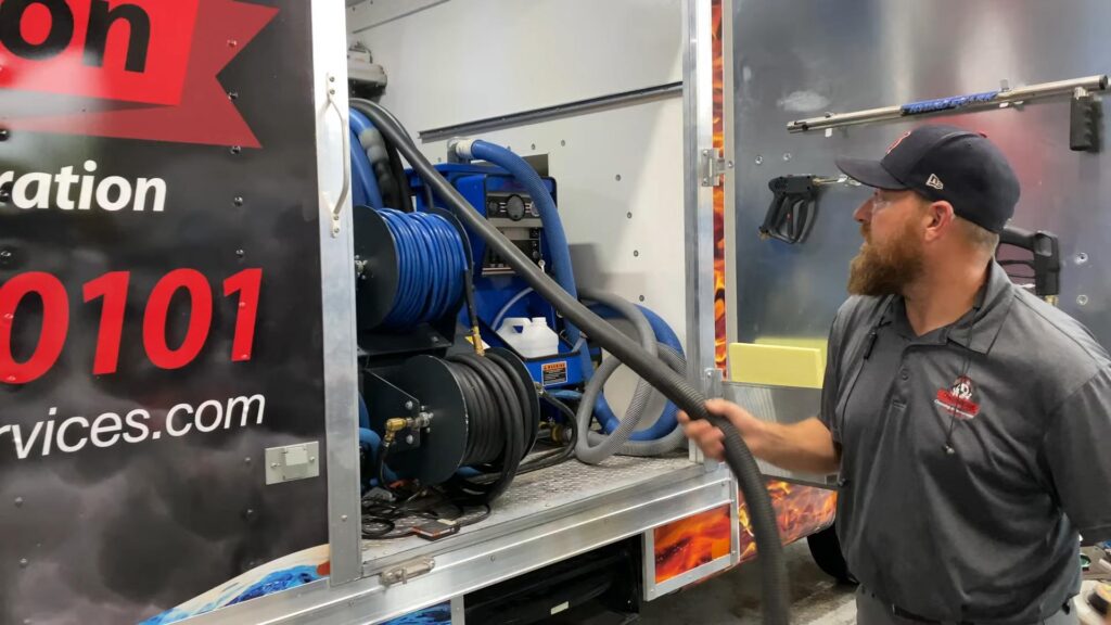 Dalmation Cleaning & Restoration - St. Louis’ Premier Disaster Recovery Services Image Of Man Pulling Hose Out Of Truck